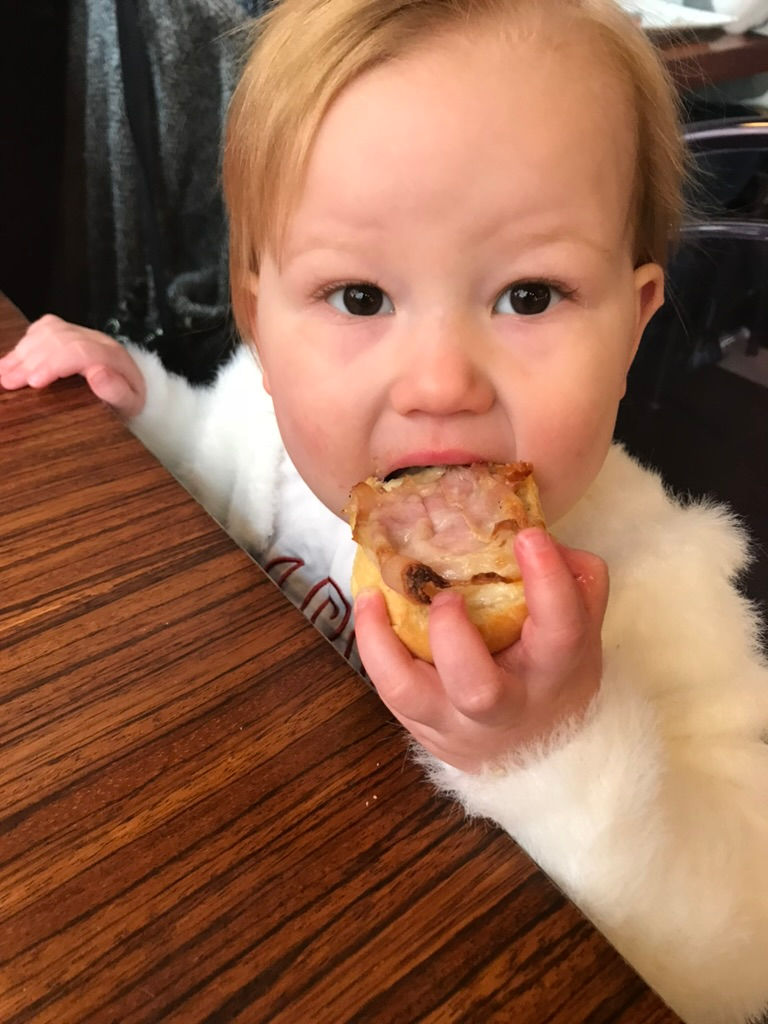 Kid eating cicchetti on a cicchetti crawl in Venice