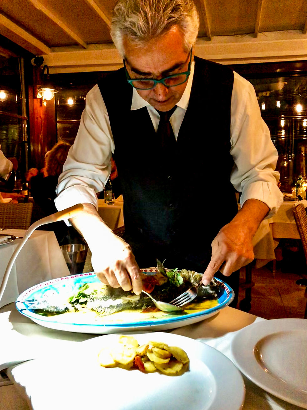 waiter serving fish at Panorama in Capri Italy
