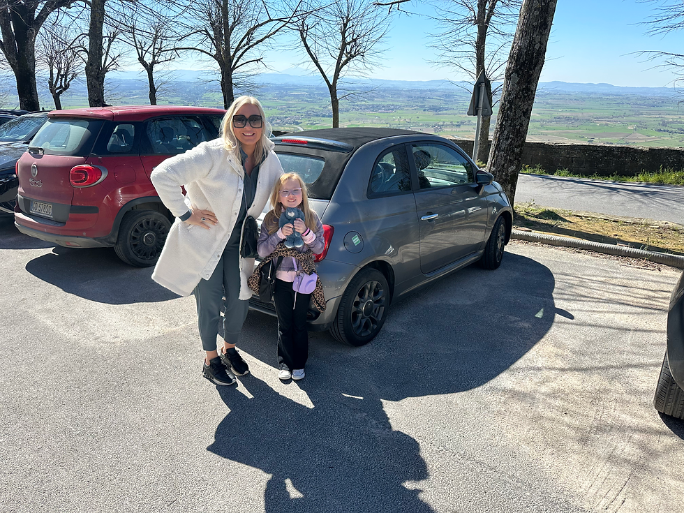 family with small rental car in tuscany italy