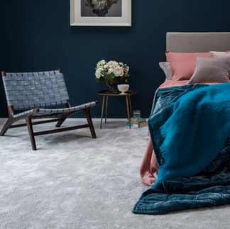 Soft carpet in cosy bedroom with blue decor.