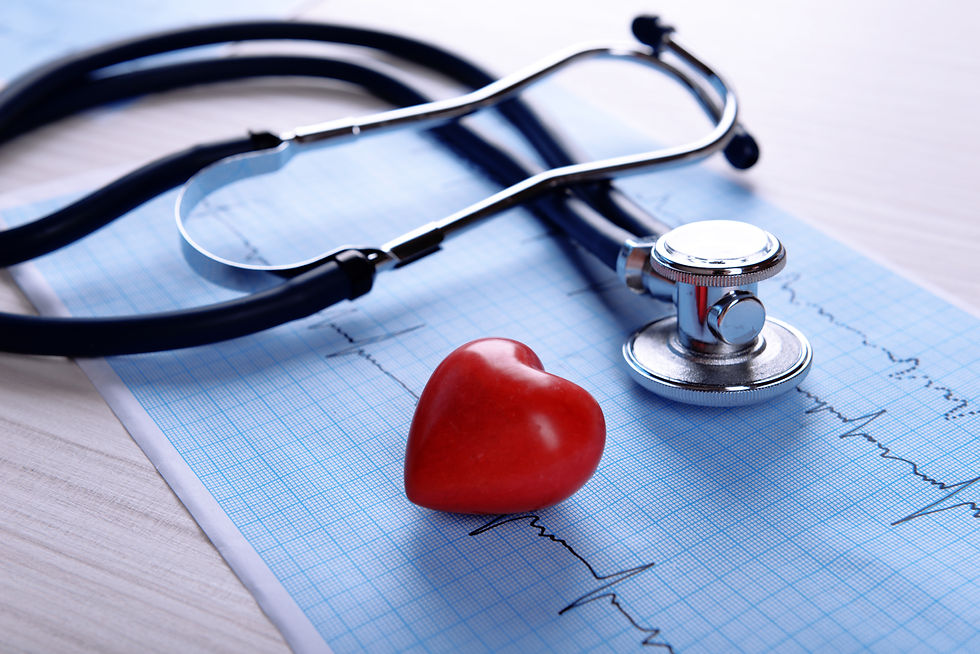 Cardiogram with stethoscope and red heart on table, closeup.jpg