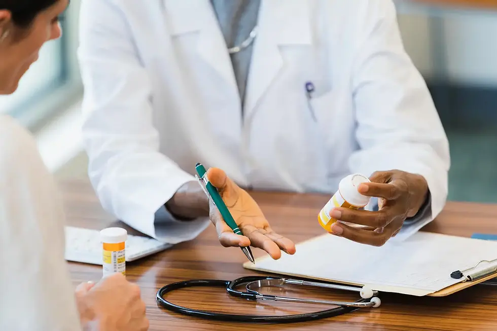 Two people sit at a table in a room with warm light. One wears a yellow shirt and a headscarf, and the other wears blue scrubs and a cap, smiling with a hand on the other's shoulder. On the table are colorful ribbons in pink, orange, and blue, two blister packs of pills, and boxes labeled "RESILIX" and "HOPEXRA." A sign on the wall reads "STRENGTH IN EVERY STEP." Potted plants are in the background.