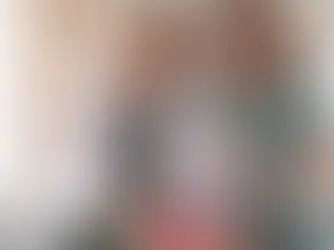 Two medical professionals examine a model of a heart in a bright, clinical setting. One takes notes, both appear focused.