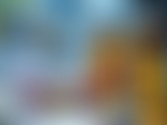 Amber pill bottles, various pills scattered on a dark surface with blurred medicine bottles and dollar bills in the background.