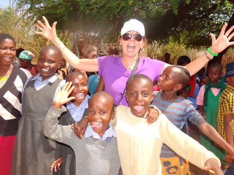 picture of woman with arms up with children.jpeg