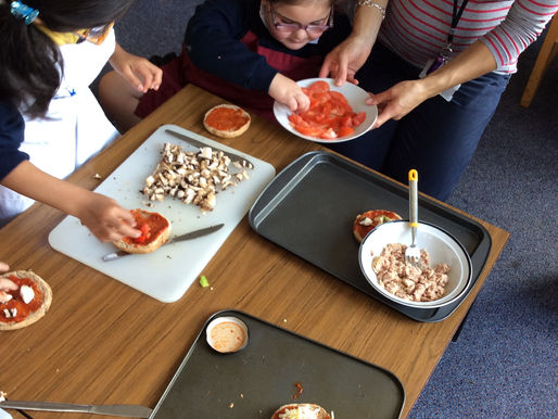 Year One enjoyed making delicious Pizzas... toppings included mushrooms, peppers, and tomatoes...