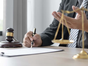 CPA at a desk showing a client how to navigate the 2026 tax Season with scales of justice in the foreground