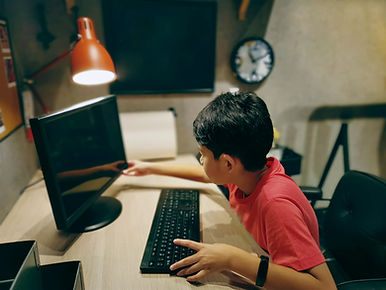 Kid turning on computer.jpg