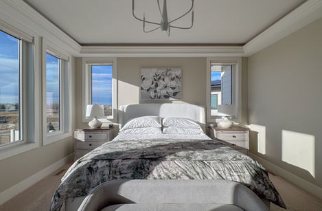 Bedroom with a bed, large windows, and natural light