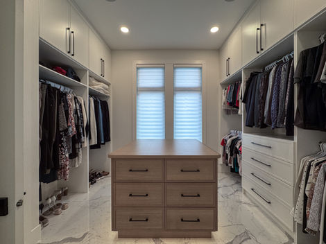 Spacious walk-in closet with island and window