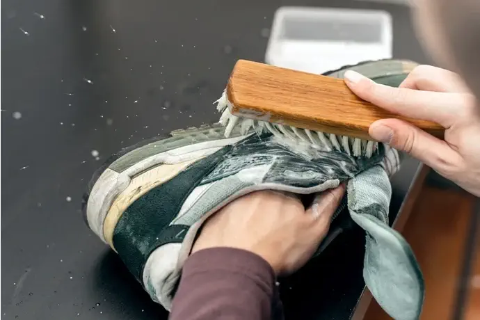 brushing off sneaker