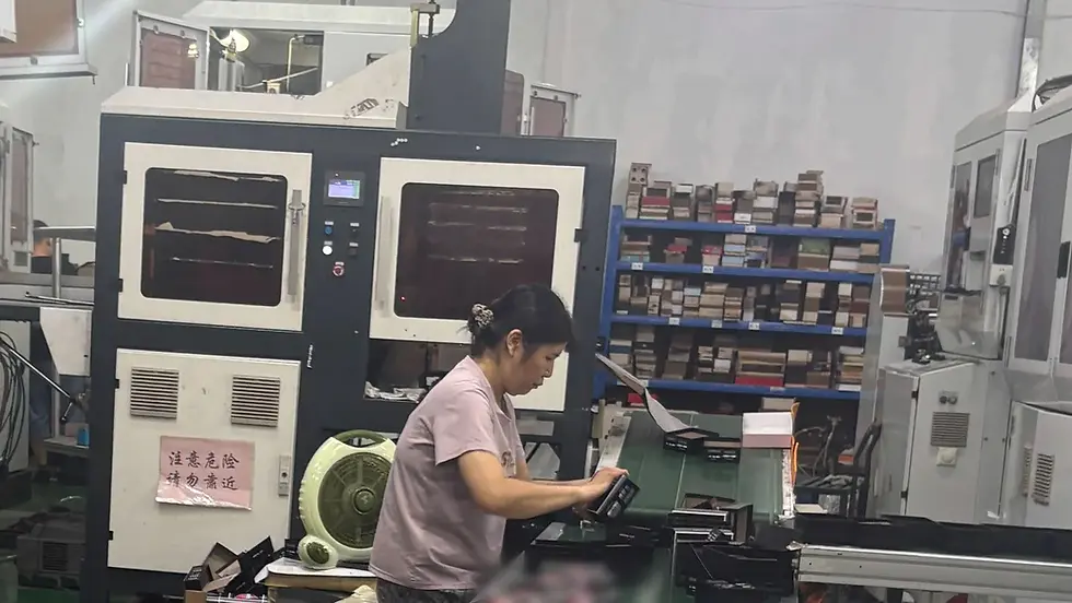 Rigid box machine and finished rigid boxes on the line at BOYA Printing, Zhongshan