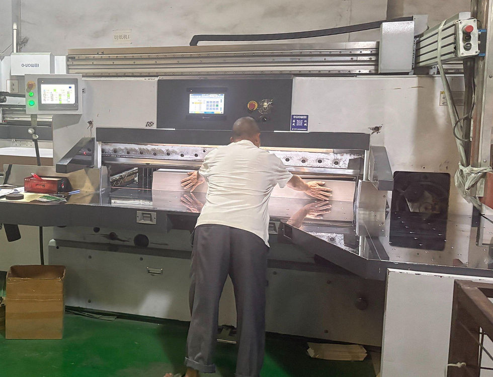 Guillotine paper cutter trimming board for printed color boxes at BOYA Printing's factory in Zhongshan, China