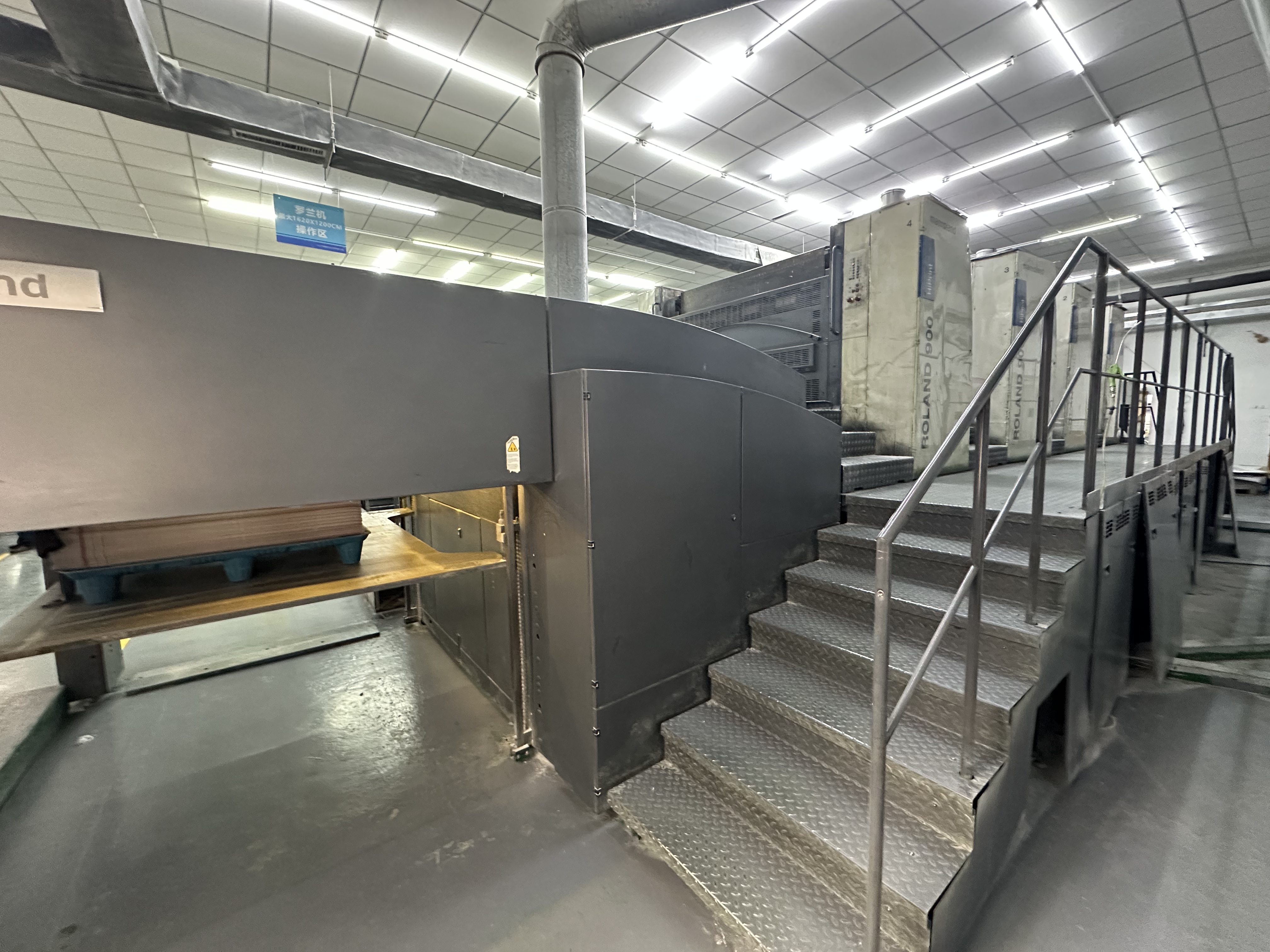 Side view of a printing press in the BOYA Printing workshop.
