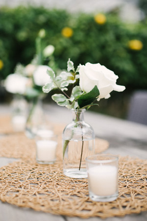 white flowers in bud vases