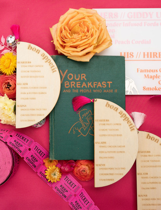 flatlay of wedding details with hot pink accents