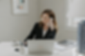 Professional woman in modern office workspace.png