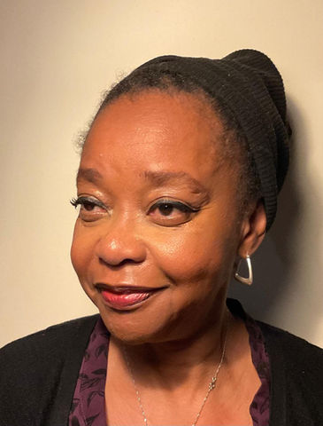 Headshot: Woman wearing a black beanie