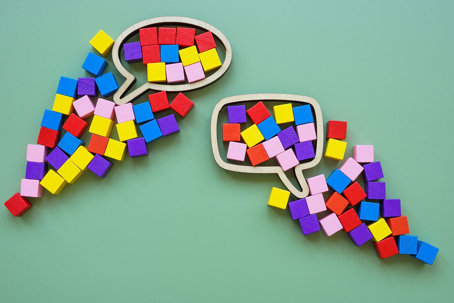 Speech bubble and colorful cubes. Inclusive language concept..jpg
