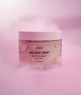 Kenzako AHA body scrub surrounded by pink lights and clouds