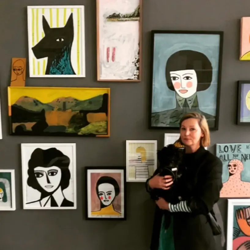 Woman standing in front of paintings
