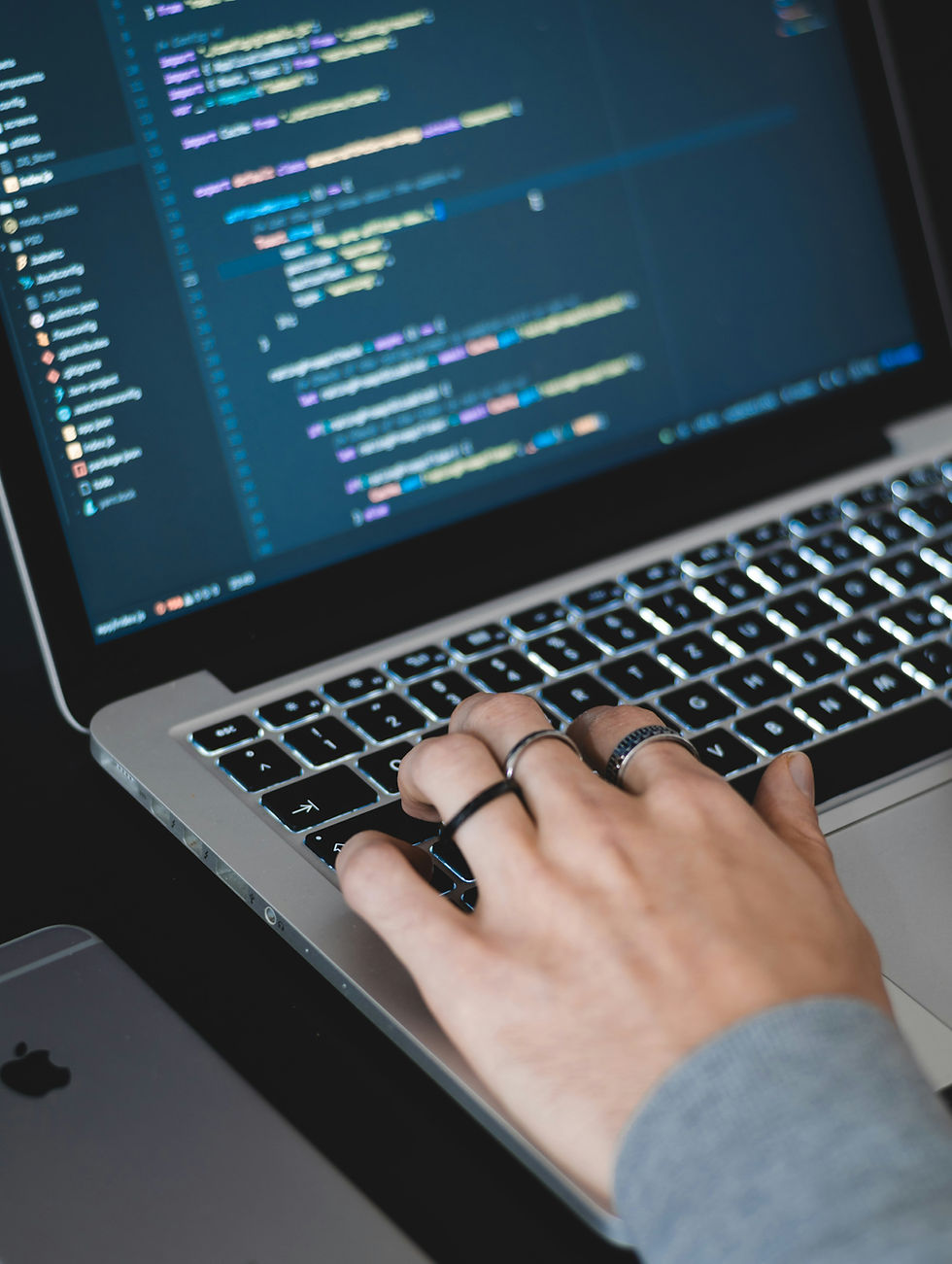 Someone coding on a MacBook