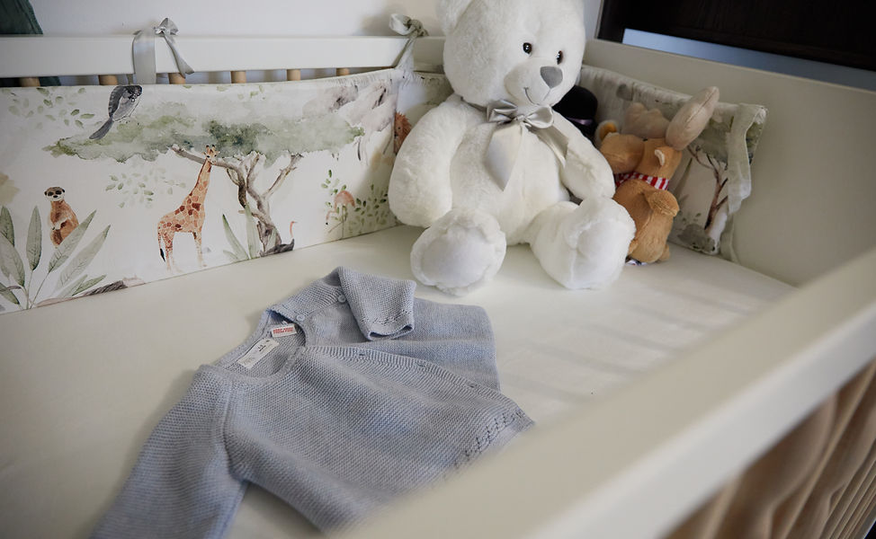 babay bed in baptise day, and a white bear and clothes of the baby in blue color - cameraman botez bucuresti