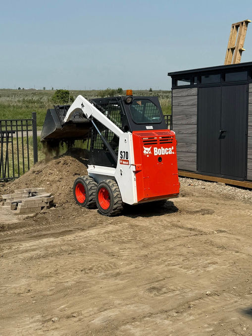 Bobcat S70 loader parked outside a shed, highlighting equipment rental services available in Saskatoon.