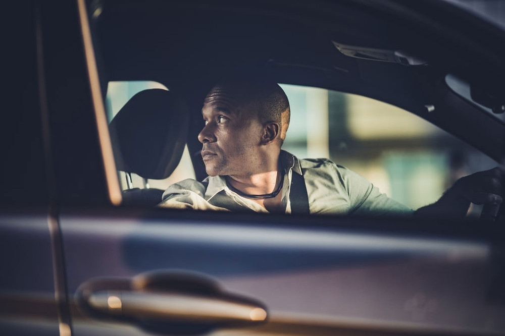 Mid-adult-black-businessman-reversing-his-car