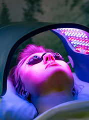 Client resting under Celluma LED light therapy during a facial rejuvenation treatment