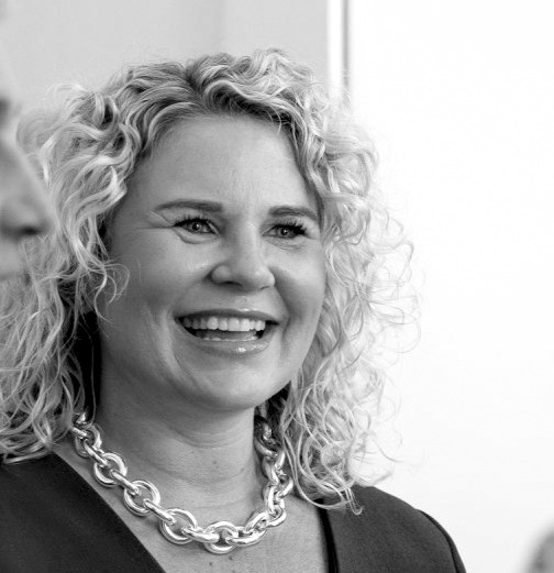 A black and white photo of the owner Nicola with a friendly smile