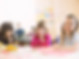 Smiling girls sitting at table in elementary class
