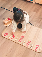 Child working with Montessori numbers materials
