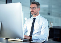 shot-of-a-businessman-using-his-computer-while-sit-2023-11-27-05-09-20-utc