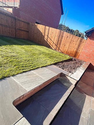 Stepped garden with lawn and Kandle grey flags