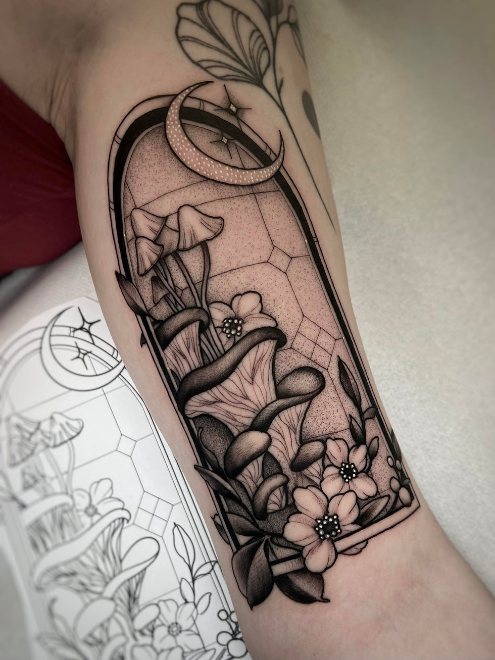Blackwork mushroom tattoo inside arched frame with crescent moon and floral elements, esoteric gothi