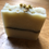 Thumbnail: Chamomile topped creamy coloured soap bar.