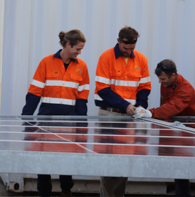 FPS20-20 hybrid power system with solar panels supplying temporary power at a remote construction site.