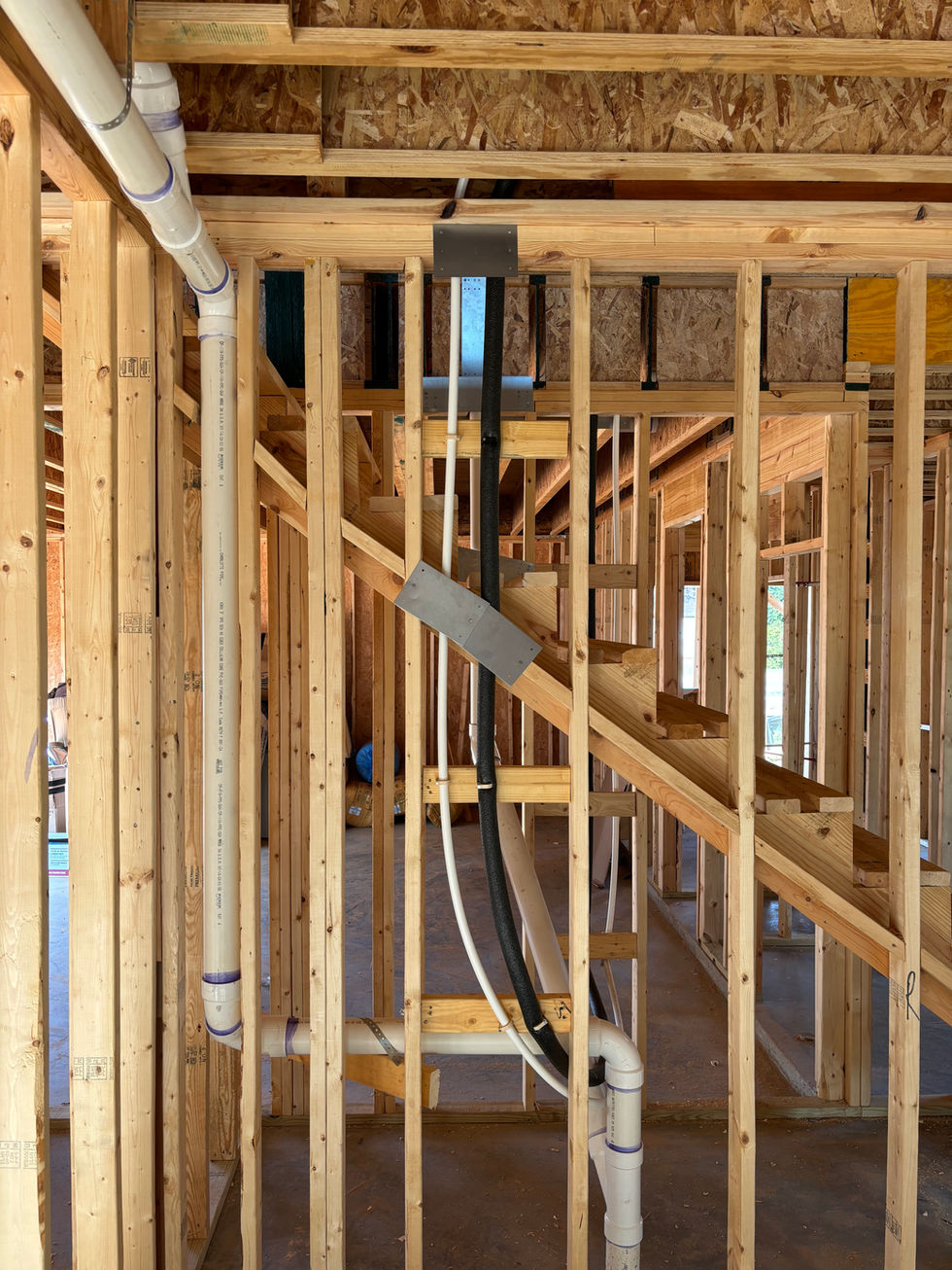 Under stair drain line installation in new construction plumbing by The Right Way Plumber Georgia custom home