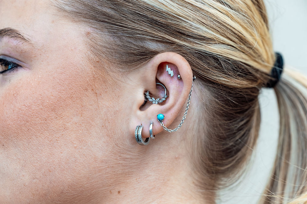Ear curation piercings by Adam