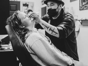 Adam the Piercer piercing a nostril