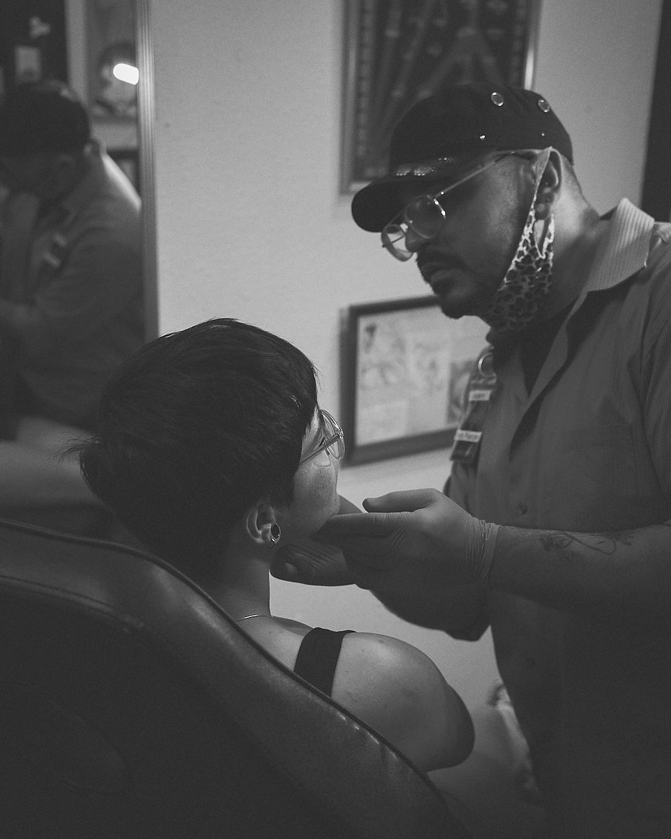 Adam the piercer talking to a client