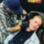 Adam the piercer piercing an ear