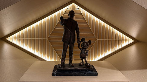 Walt Disney and Mickey Mouse statue in a room, on display