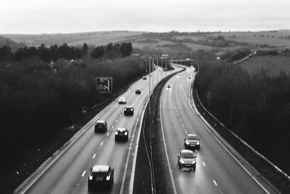 Black and white highway with moving cars. Wojciech J Walkowicz