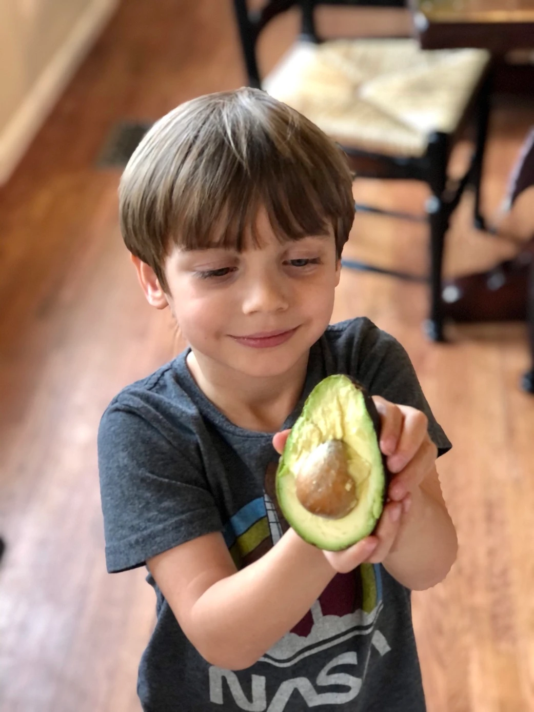 Boy holding an avocado