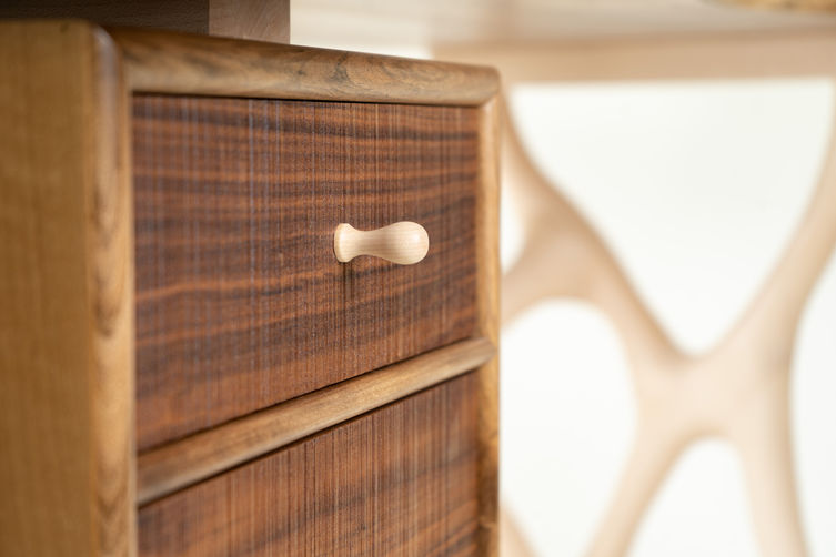 Close up shot of textured walnut drawer fronts of office desk