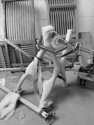 Sculptural leg support of office desk under construction