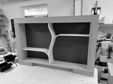 Black and white photo showing precision woodworking during the assembly of a bespoke drinks cabinet.