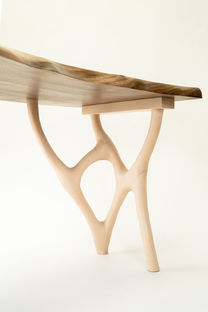 A sculptural leg support structure made from carefully jointed sycamore and connected to the top with locking dovetails to allow for movement.